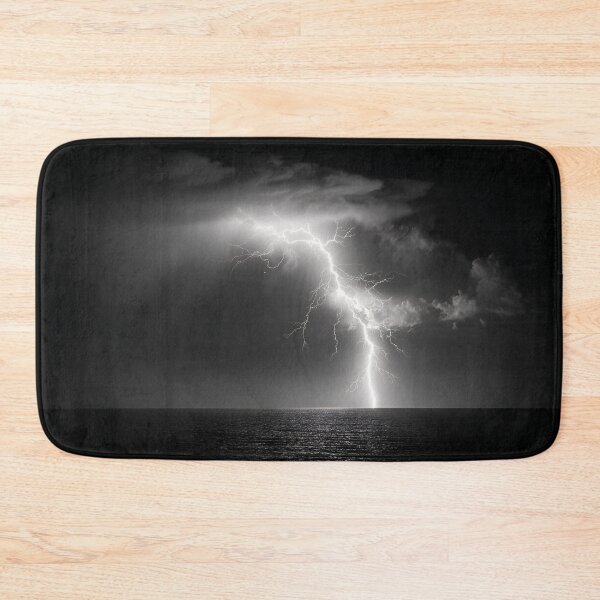 Item preview, Ocean lightning strike fine art photograph of a lightning bolt striking over a dark sea black and white photograph art print designed and sold by Astrid Arkhangelsky.