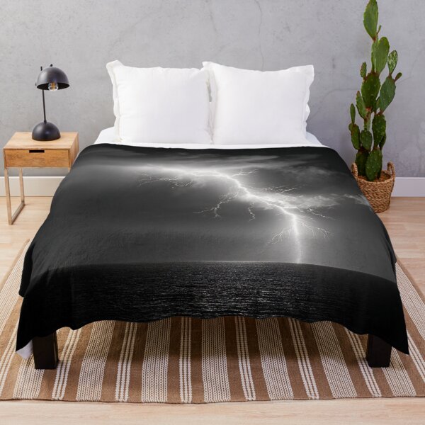 Item preview, Ocean lightning strike fine art photograph of a lightning bolt striking over a dark sea black and white photograph art print designed and sold by Astrid Arkhangelsky.