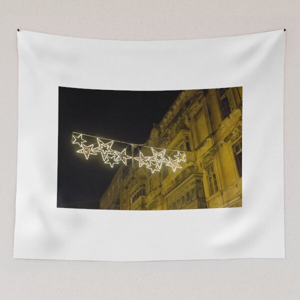 Item preview, Christmas Star Street Lights Hanging Above Historic Building Facade at Night Holiday Decoration designed and sold by Nmallia.