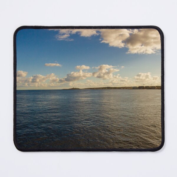 Item preview, Calm Ocean Horizon With Cloud-Filled Sky and Distant Coastal Island at Golden Hour designed and sold by Nmallia.
