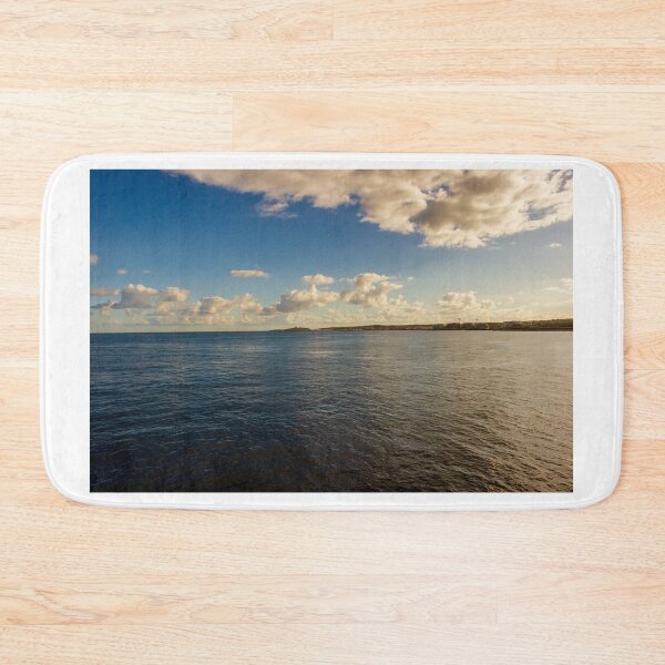 Item preview, Calm Ocean Horizon With Cloud-Filled Sky and Distant Coastal Island at Golden Hour designed and sold by Nmallia.