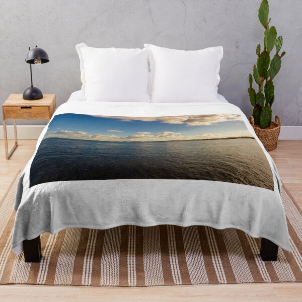 Item preview, Calm Ocean Horizon With Cloud-Filled Sky and Distant Coastal Island at Golden Hour designed and sold by Nmallia.