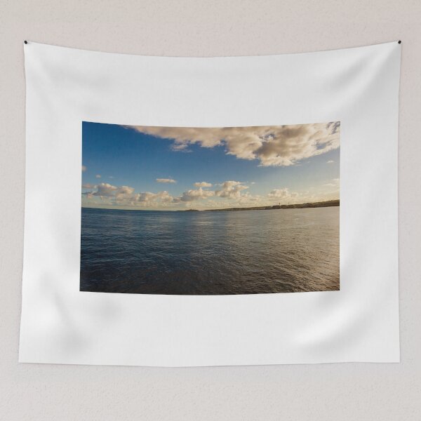 Item preview, Calm Ocean Horizon With Cloud-Filled Sky and Distant Coastal Island at Golden Hour designed and sold by Nmallia.