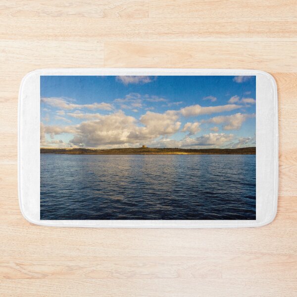Item preview, Calm Ocean Horizon With Cloud-Filled Sky and Distant Coastal Island at Golden Hour designed and sold by Nmallia.