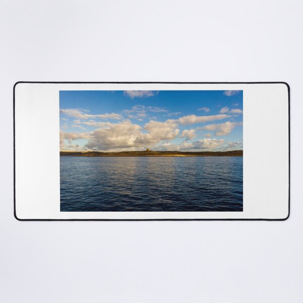 Item preview, Calm Ocean Horizon With Cloud-Filled Sky and Distant Coastal Island at Golden Hour designed and sold by Nmallia.
