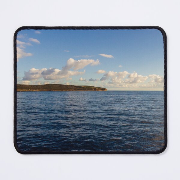 Item preview, Calm Ocean Horizon With Cloud-Filled Sky and Distant Coastal Island at Golden Hour designed and sold by Nmallia.