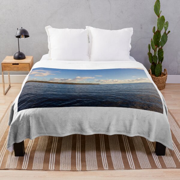 Item preview, Calm Ocean Horizon With Cloud-Filled Sky and Distant Coastal Island at Golden Hour designed and sold by Nmallia.