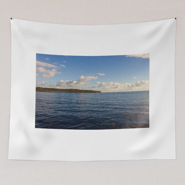 Item preview, Calm Ocean Horizon With Cloud-Filled Sky and Distant Coastal Island at Golden Hour designed and sold by Nmallia.