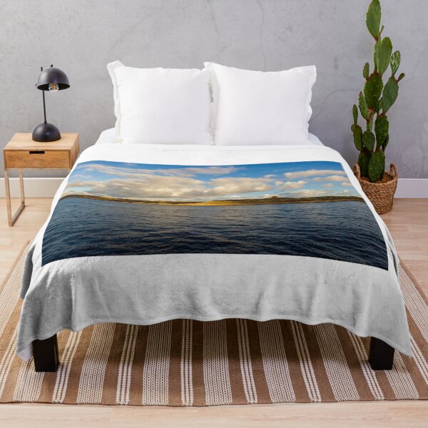 Item preview, Calm Ocean Horizon With Cloud-Filled Sky and Distant Coastal Island at Golden Hour designed and sold by Nmallia.