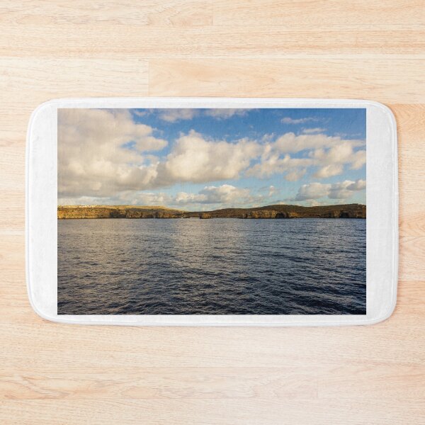 Item preview, Calm Ocean Horizon With Cloud-Filled Sky and Distant Coastal Island at Golden Hour designed and sold by Nmallia.