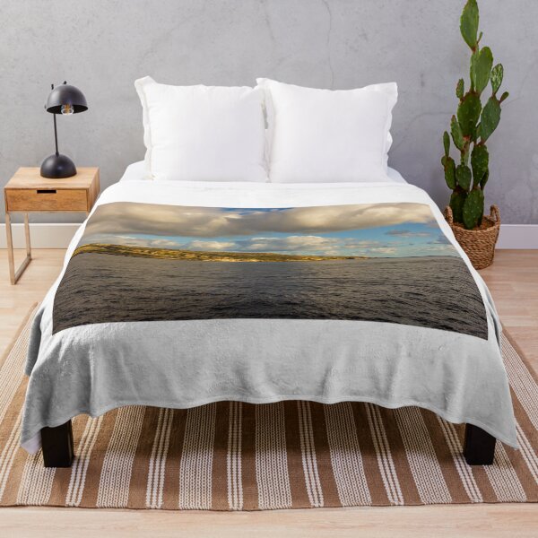Item preview, Calm Ocean Horizon With Cloud-Filled Sky and Distant Coastal Island at Golden Hour designed and sold by Nmallia.