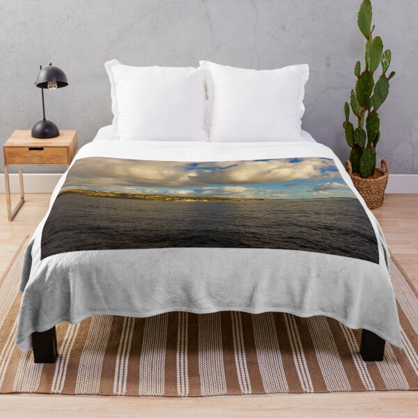 Item preview, Calm Ocean Horizon With Cloud-Filled Sky and Distant Coastal Island at Golden Hour designed and sold by Nmallia.