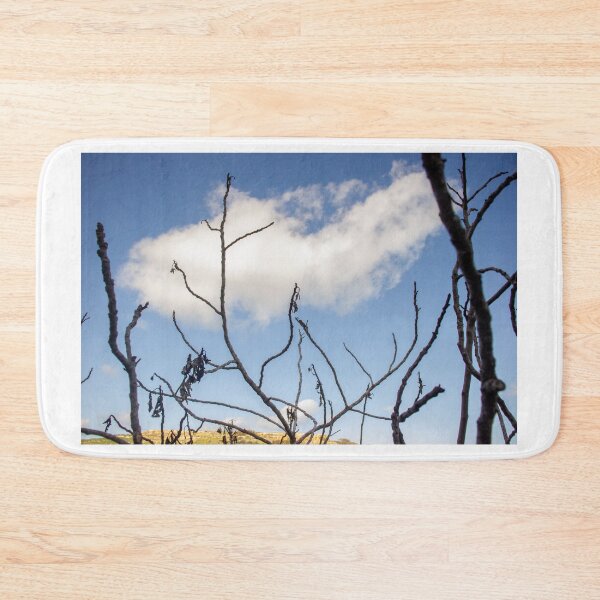 Item preview, Bare Tree Branches Silhouetted Against Blue Sky With Single Cloud Over Arid Landscape designed and sold by Nmallia.