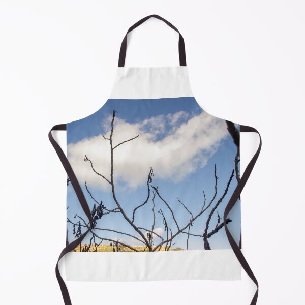 Item preview, Bare Tree Branches Silhouetted Against Blue Sky With Single Cloud Over Arid Landscape designed and sold by Nmallia.