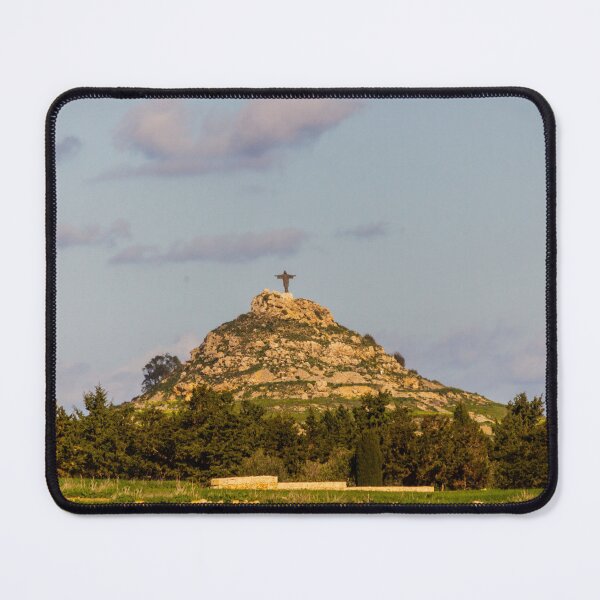 Item preview, Lone Christ Statue Monument On Rocky Hill Overlooking Green Countryside At Golden Hour designed and sold by Nmallia.
