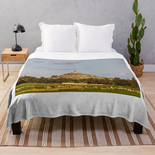 Item preview, Lone Christ Statue Monument On Rocky Hill Overlooking Green Countryside At Golden Hour designed and sold by Nmallia.