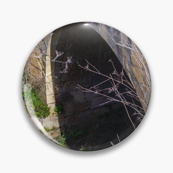 Item preview, Old Stone Arch Bridge With Dark Tunnel Entrance Surrounded by Overgrown Vegetation designed and sold by Nmallia.
