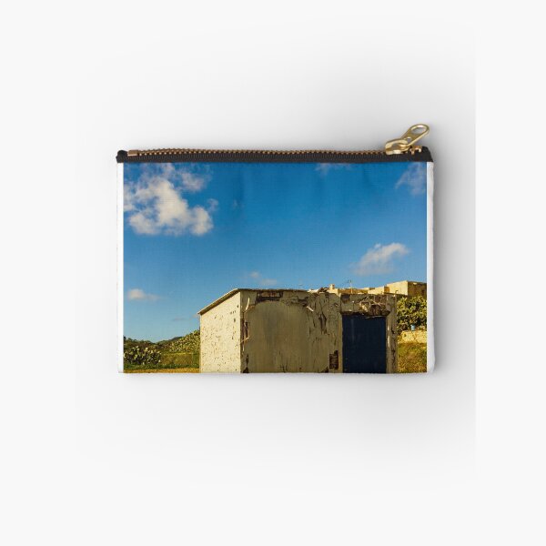 Item preview, Weathered Rural Shed With Peeling Paint And Blue Door Under Bright Cloudy Sky designed and sold by Nmallia.