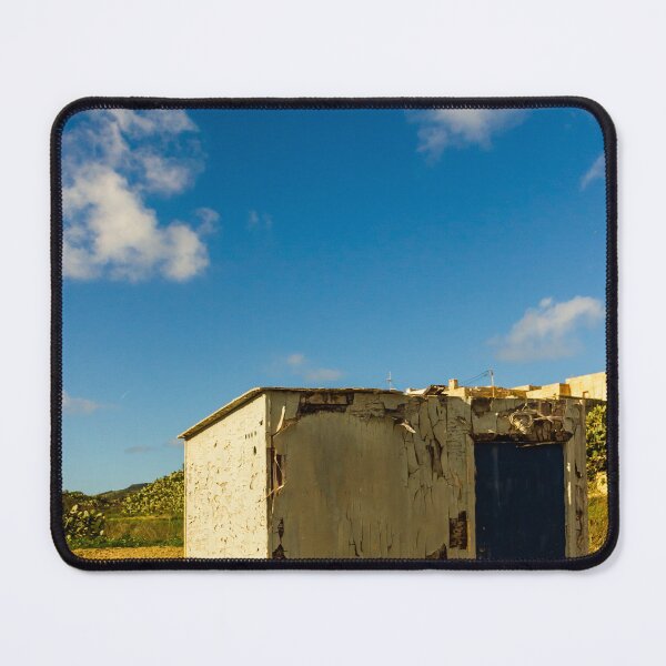 Item preview, Weathered Rural Shed With Peeling Paint And Blue Door Under Bright Cloudy Sky designed and sold by Nmallia.