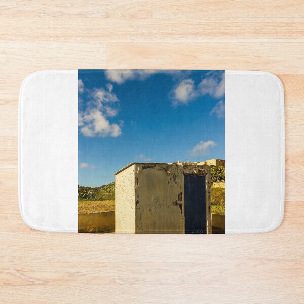 Item preview, Weathered Rural Shed With Peeling Paint And Blue Door Under Bright Cloudy Sky designed and sold by Nmallia.