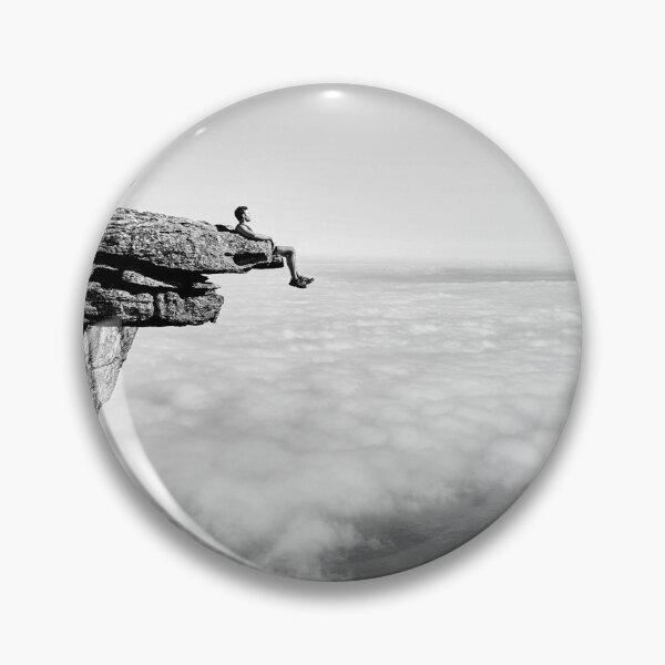 Item preview, On top of the world, daredevil sitting upon rock face cliff black and white fine art photographic art print designed and sold by Astrid Arkhangelsky.