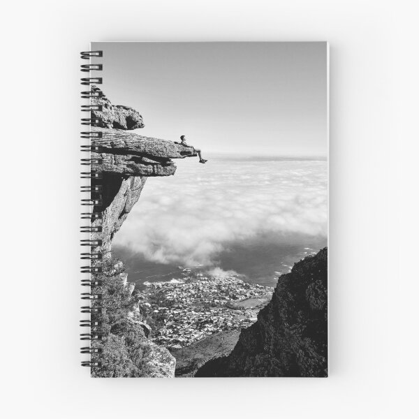 Item preview, On top of the world, daredevil sitting upon rock face cliff black and white fine art photographic art print designed and sold by Astrid Arkhangelsky.