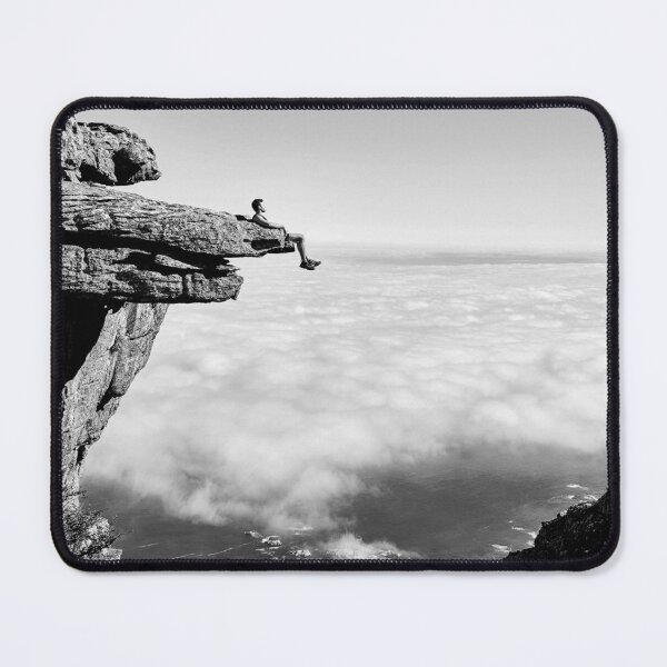 Item preview, On top of the world, daredevil sitting upon rock face cliff black and white fine art photographic art print designed and sold by Astrid Arkhangelsky.
