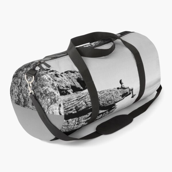 Item preview, On top of the world, daredevil sitting upon rock face cliff black and white fine art photographic art print designed and sold by Astrid Arkhangelsky.