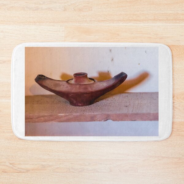 Item preview, Antique Terracotta Oil Lamp On Wooden Shelf With Warm Shadow And Rustic Texture designed and sold by Nmallia.