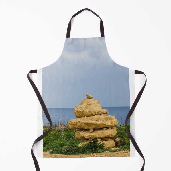 Item preview, Stacked Coastal Rocks Beside Calm Sea Under Cloudy Sky With Green Vegetation And Wildflowers designed and sold by Nmallia.
