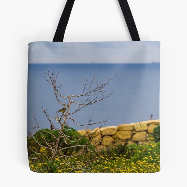 Item preview, Lonely Bare Tree With Small Bird by Stone Wall Overlooking Calm Sea and Wildflower Coastline designed and sold by Nmallia.