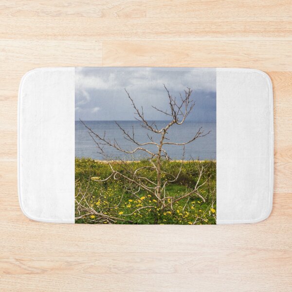 Item preview, Lonely Bare Tree With Small Bird by Stone Wall Overlooking Calm Sea and Wildflower Coastline designed and sold by Nmallia.