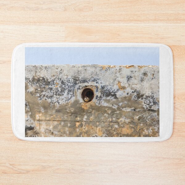 Item preview, Small Bird Peeking From Nesting Hole in Weathered Concrete Wall With Blue Sky Background designed and sold by Nmallia.