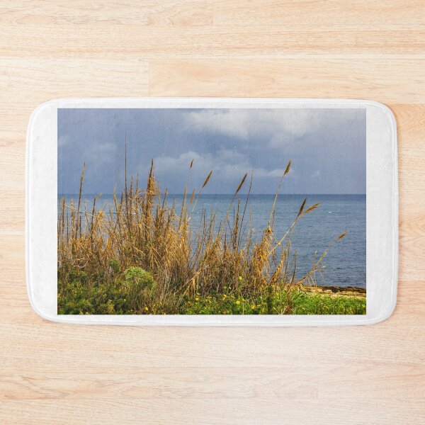 Item preview, Stormy Coastal Seascape With Golden Reeds in Foreground and Calm Blue Sea Horizon designed and sold by Nmallia.