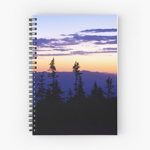 Item preview, Silhouetted pines stand against a glowing sunset over layered mountain ridges designed and sold by Kabbrisons.