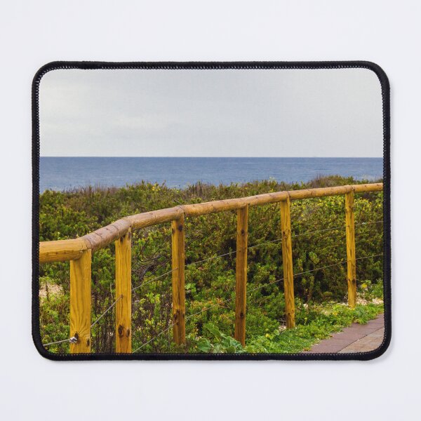 Item preview, Curved Wooden Fence Along Coastal Path Overlooking Ocean and Lush Dunes on Overcast Day designed and sold by Nmallia.