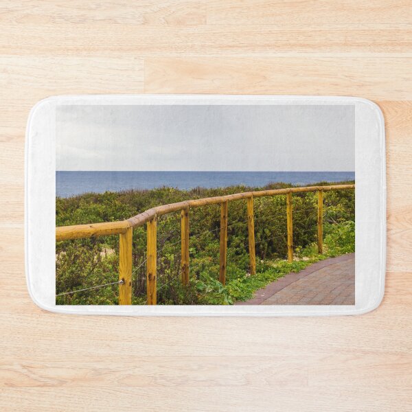 Item preview, Curved Wooden Fence Along Coastal Path Overlooking Ocean and Lush Dunes on Overcast Day designed and sold by Nmallia.