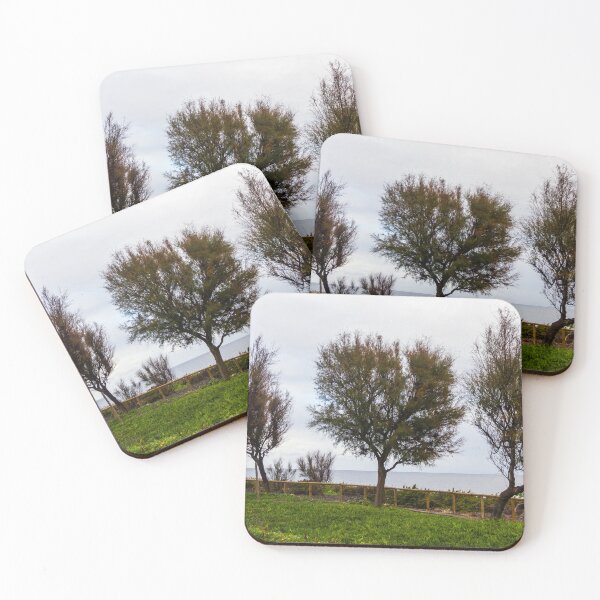 Item preview, Wind-Swept Coastal Trees Along a Green Seaside Path Overlooking Calm Ocean Horizon on Cloudy Day designed and sold by Nmallia.
