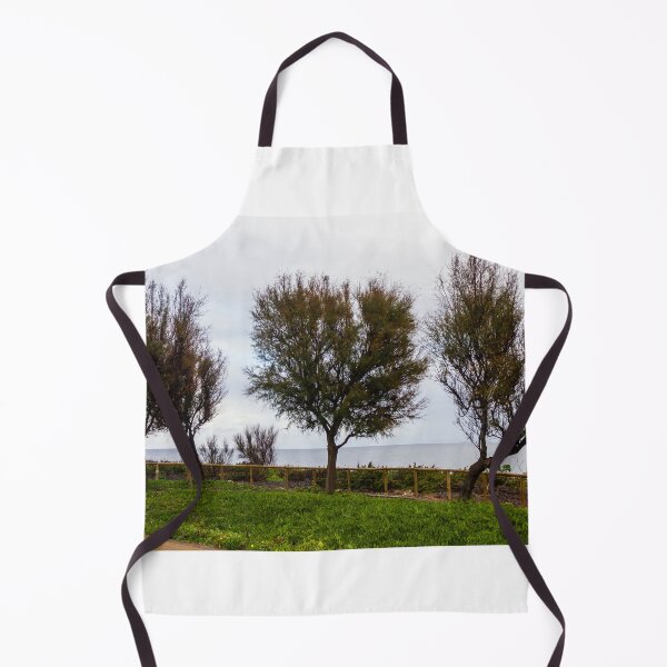 Item preview, Wind-Swept Coastal Trees Along a Green Seaside Path Overlooking Calm Ocean Horizon on Cloudy Day designed and sold by Nmallia.