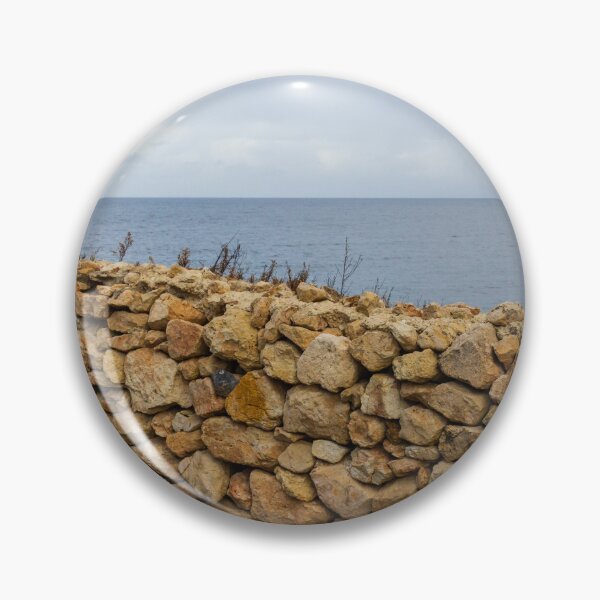 Item preview, Rugged Stone Wall Along Coastal Promenade Overlooking Calm Sea Under Overcast Sky designed and sold by Nmallia.