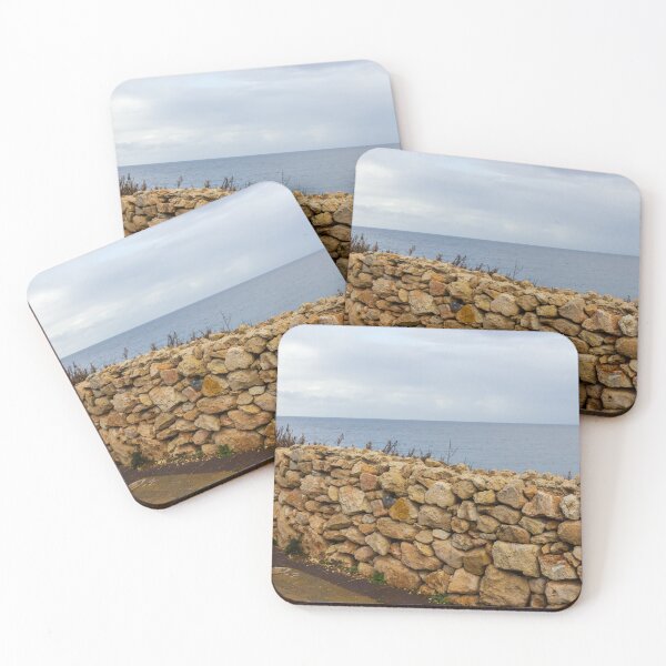 Item preview, Rugged Stone Wall Along Coastal Promenade Overlooking Calm Sea Under Overcast Sky designed and sold by Nmallia.