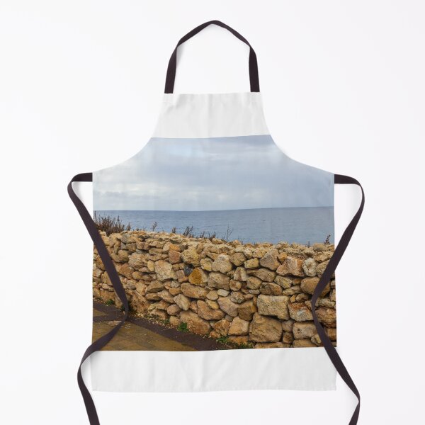 Item preview, Rugged Stone Wall Along Coastal Promenade Overlooking Calm Sea Under Overcast Sky designed and sold by Nmallia.
