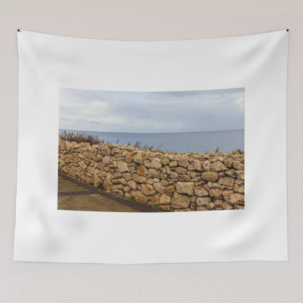 Item preview, Rugged Stone Wall Along Coastal Promenade Overlooking Calm Sea Under Overcast Sky designed and sold by Nmallia.