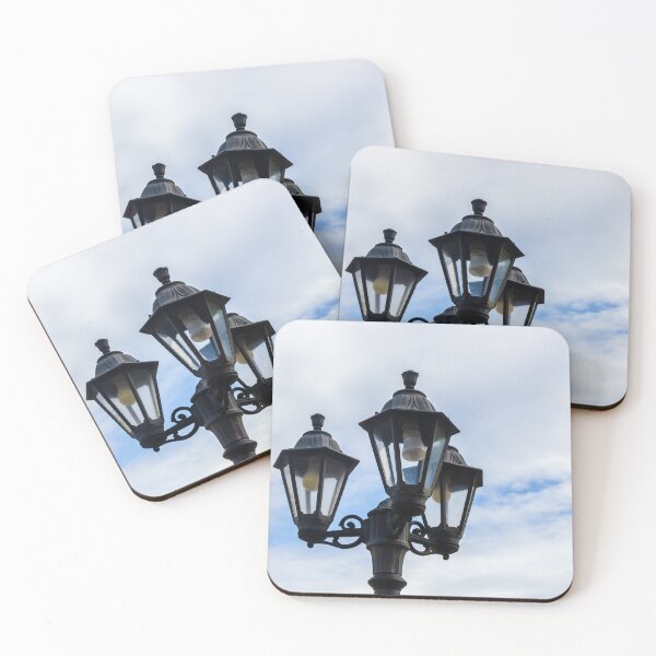 Item preview, Vintage Three-Head Street Lamp Lantern On Decorative Lamppost Against Blue Cloudy Sky designed and sold by Nmallia.