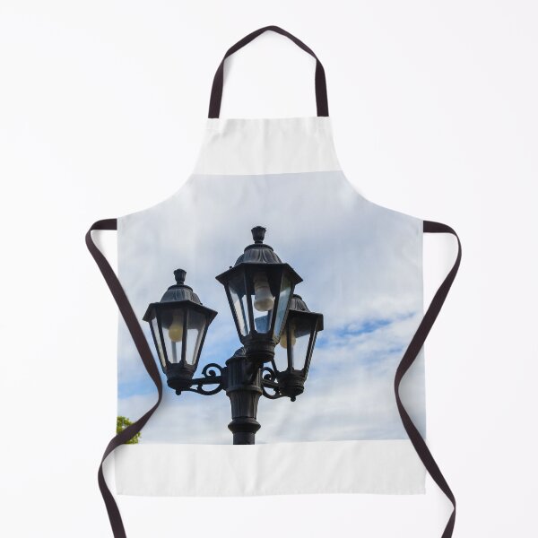 Item preview, Vintage Three-Head Street Lamp Lantern On Decorative Lamppost Against Blue Cloudy Sky designed and sold by Nmallia.