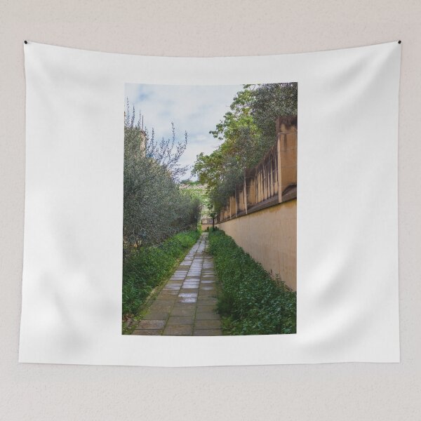 Item preview, Tranquil Paved Garden Path Along Stone Wall Surrounded By Green Foliage And Olive Trees designed and sold by Nmallia.