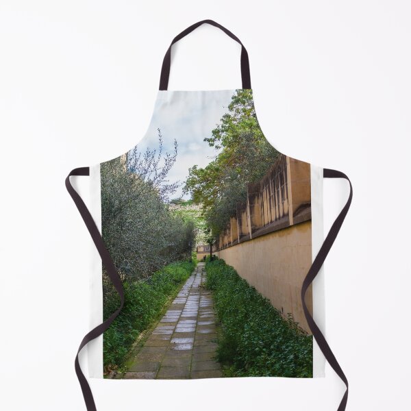 Item preview, Tranquil Paved Garden Path Along Stone Wall Surrounded By Green Foliage And Olive Trees designed and sold by Nmallia.