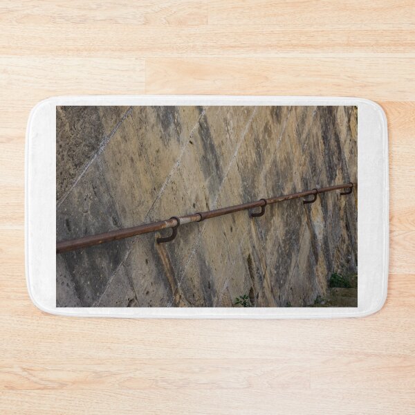 Item preview, Rusty Handrail Along Weathered Stone Wall Beside Outdoor Staircase With Textured Architectural Detail designed and sold by Nmallia.