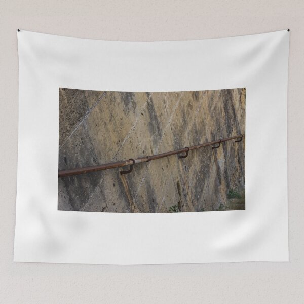 Item preview, Rusty Handrail Along Weathered Stone Wall Beside Outdoor Staircase With Textured Architectural Detail designed and sold by Nmallia.