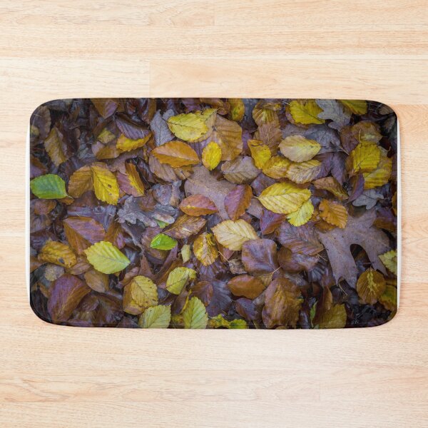 Item preview, Directly above shot of mixed autumn leaves with yellow, brown and green colors on the forest soil designed and sold by kristofbellens.